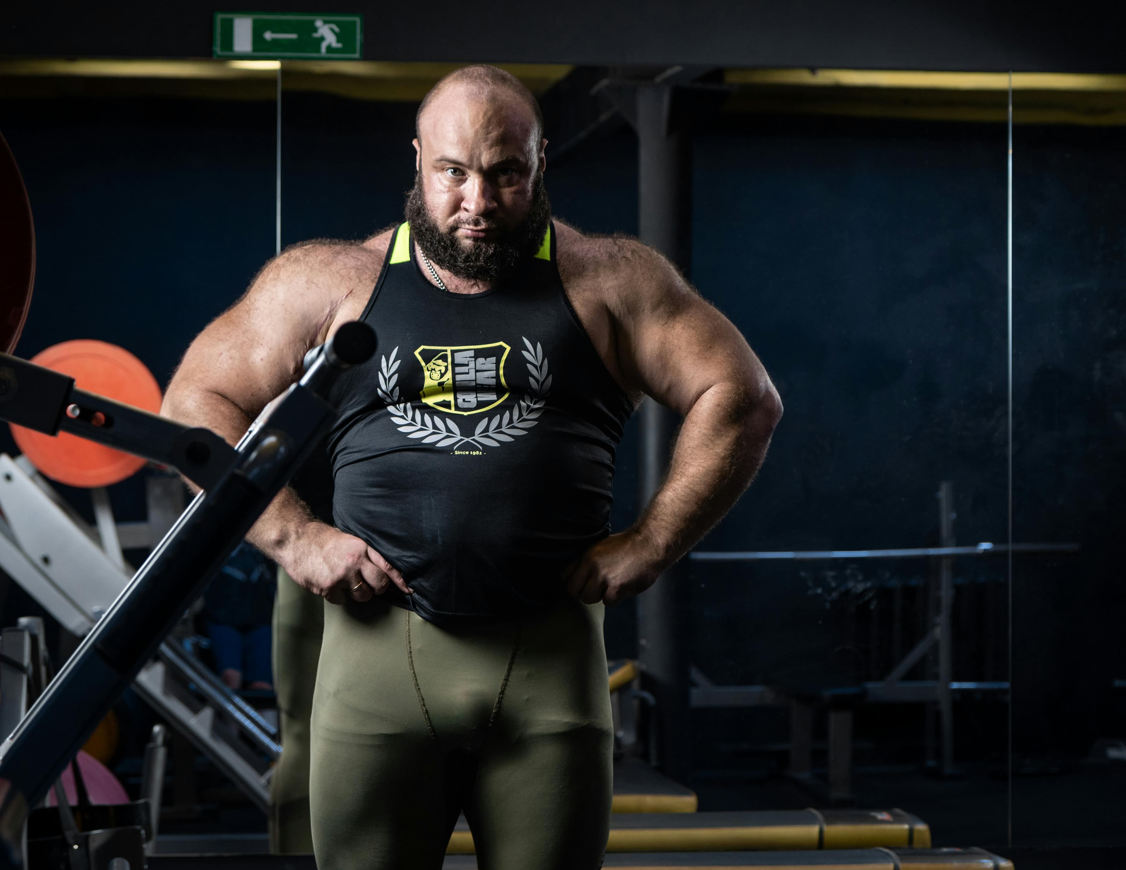 Muscular athlete posing in a gym