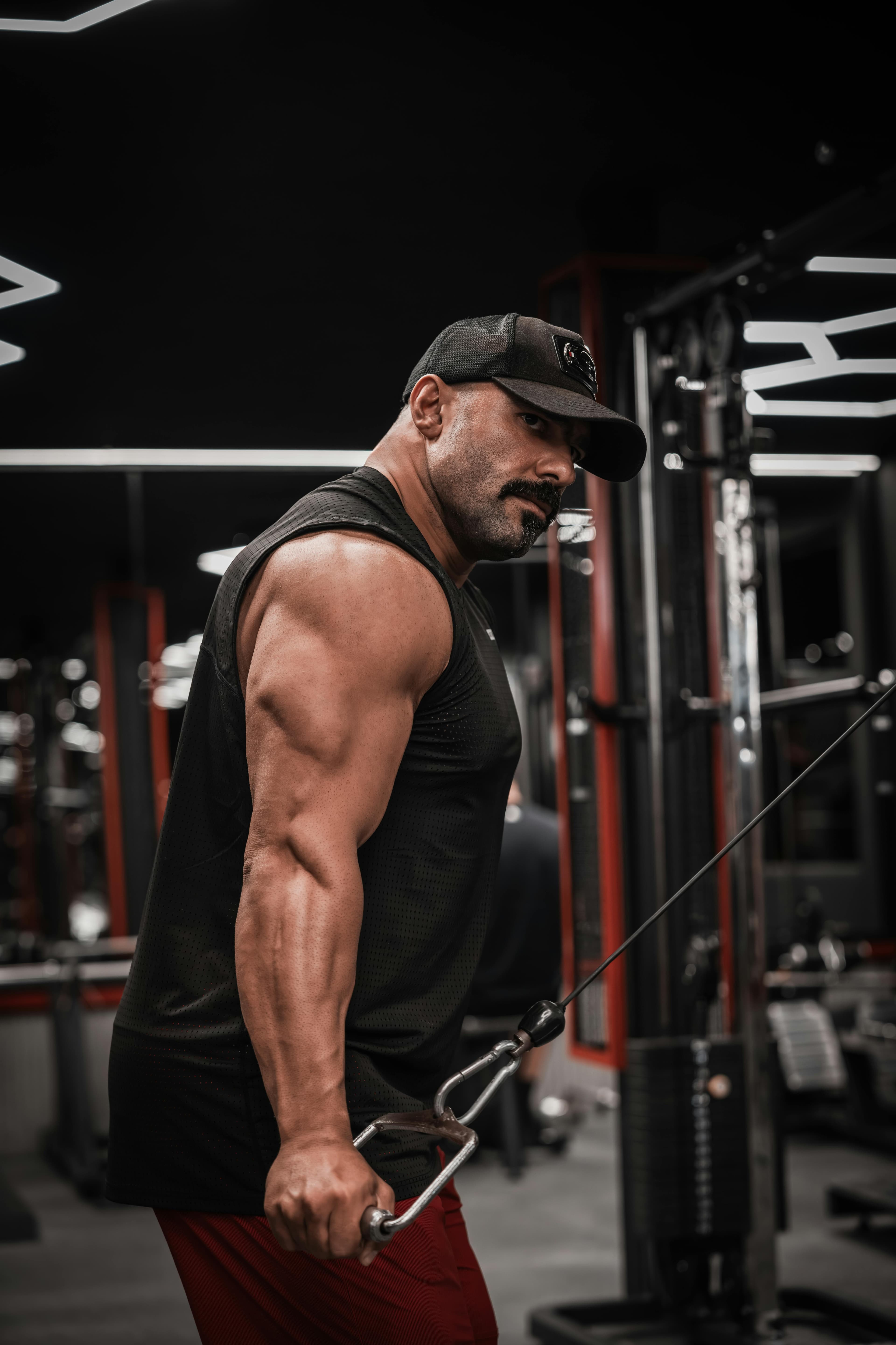 Athlete training with a cable machine in a gym